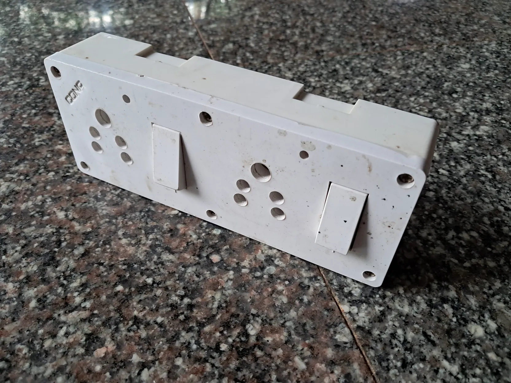Old plastic extension board with a cracked body