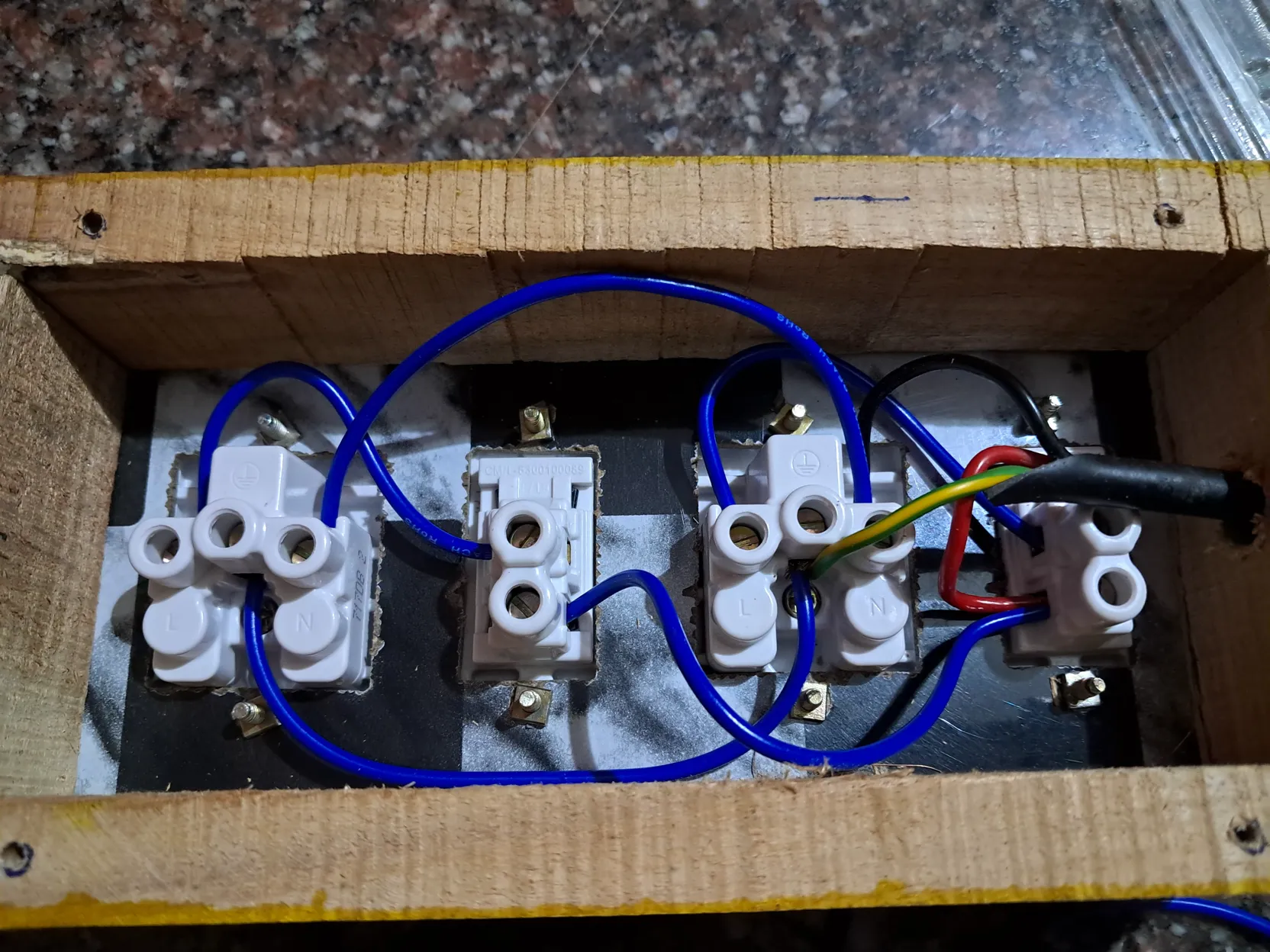 Interior wiring showing blue jumper leads clamped directly into terminal blocks