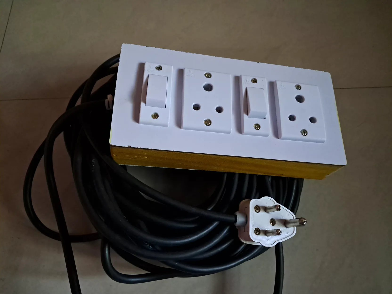 Finished wooden extension box with a neatly over-under coiled cable