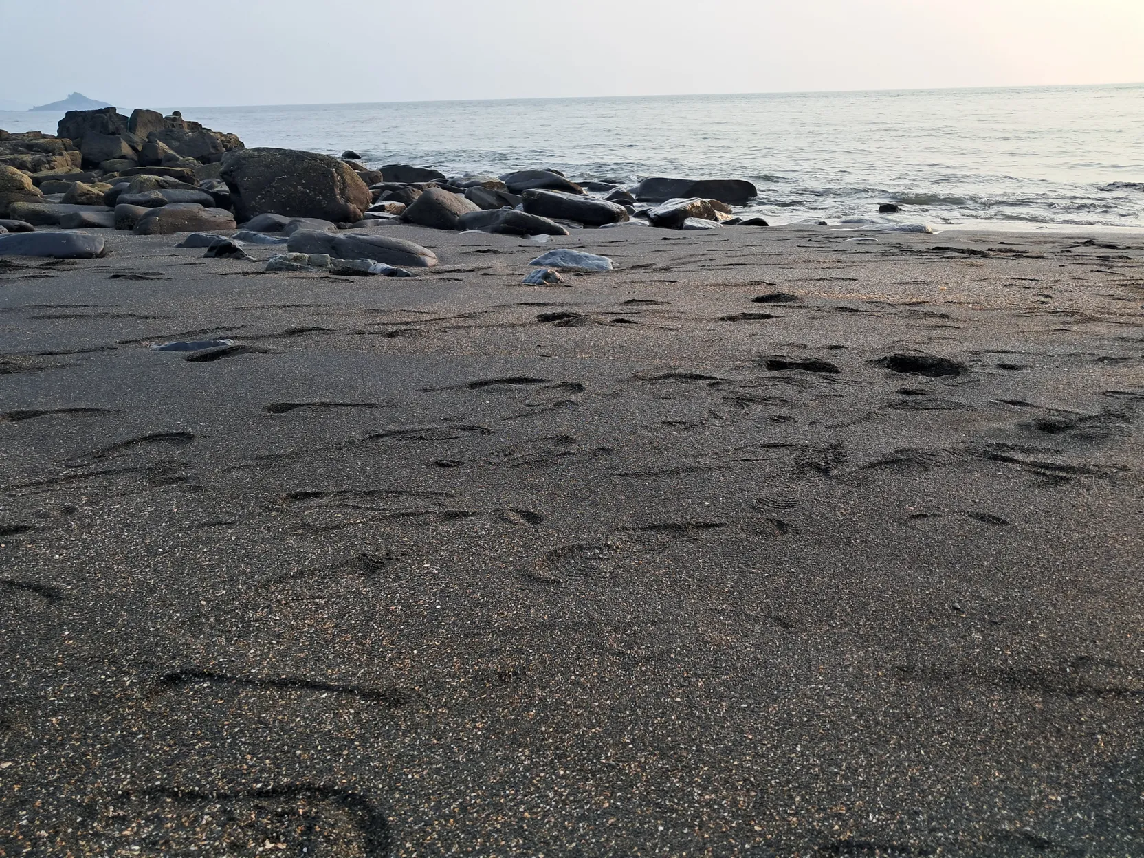 Rocks and a quiet shoreline at Tilmati
